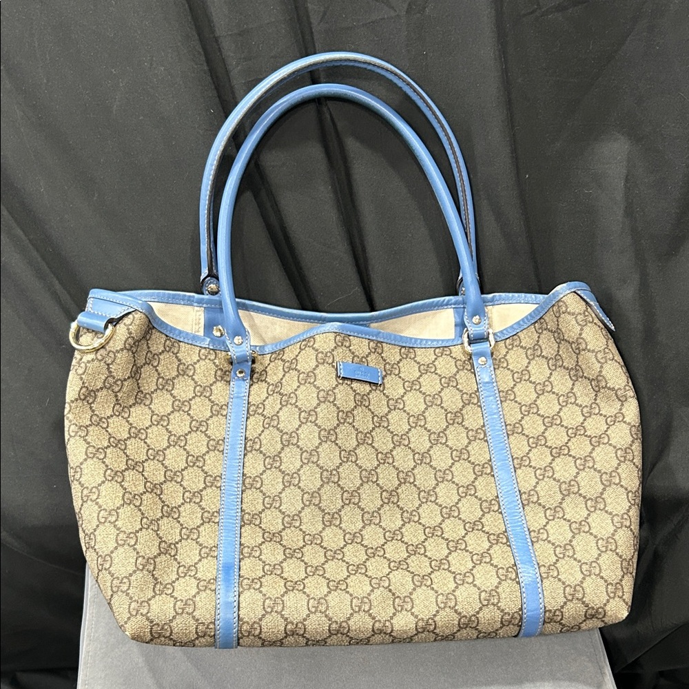 Gucci GG Supreme Joy tote bag featuring blue leather trim